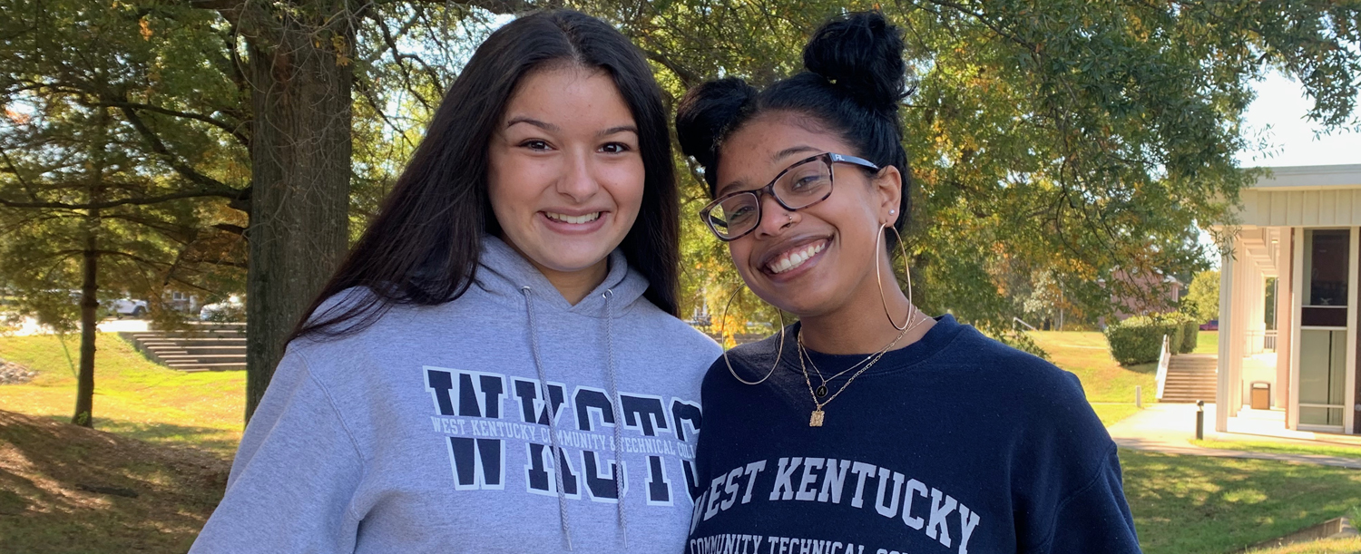 Two students looking at camera