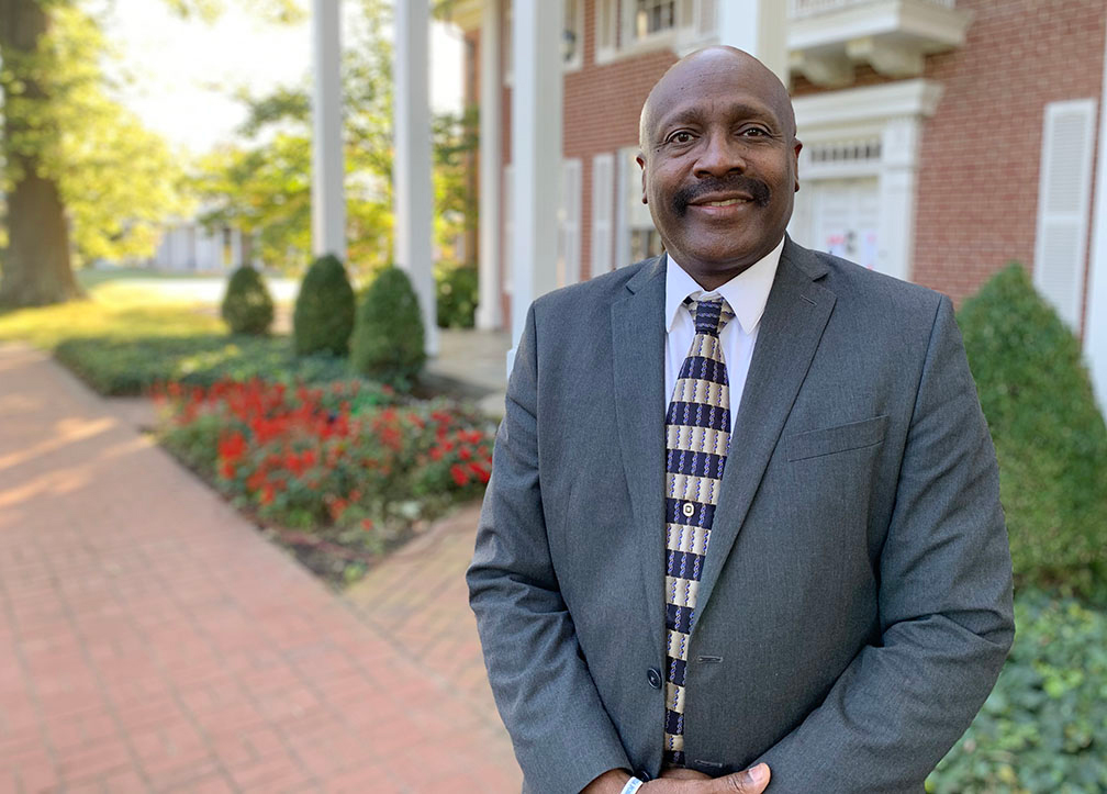 Dr. Reece in front of Carson Hall