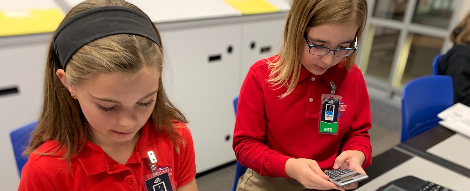 two young girls learning at the center