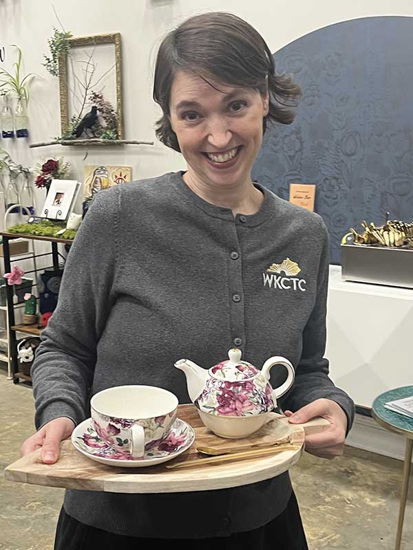 Lady holding teapot and teacup