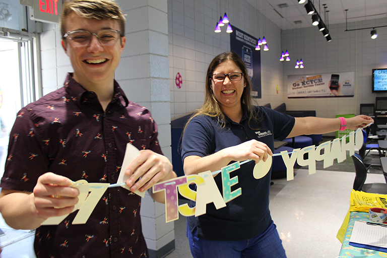 two students decorating the student center