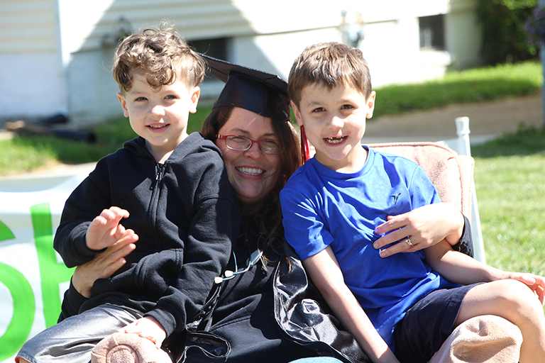 a graduate holding her grandsons