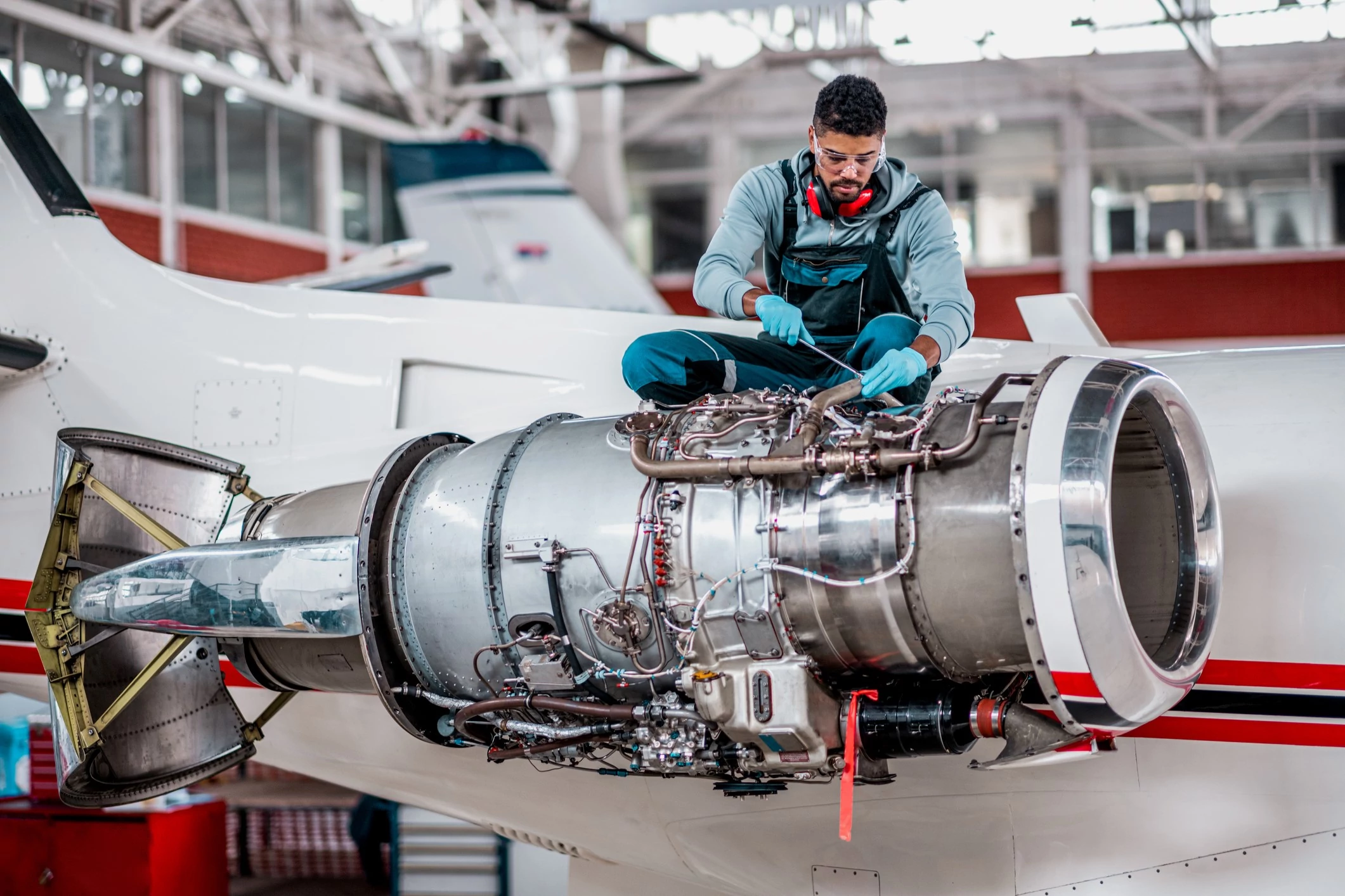 Person working on air craft engine. 