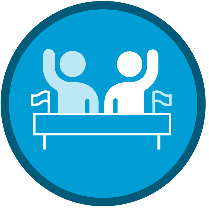 incon of 2 people standing at a podium