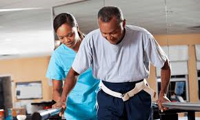 A PTA assisting a patient walking