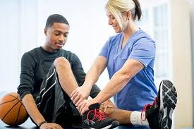 PTA helping a basketball player bending their knee